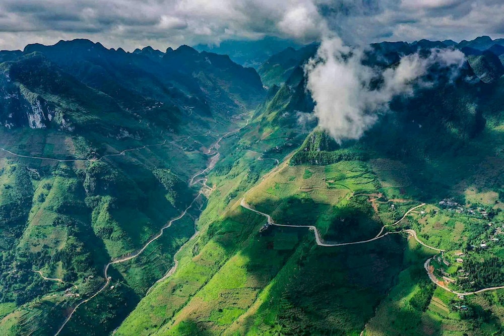 Layers of fog rolling over the peaks, adding a mysterious and dramatic effect to the scenery